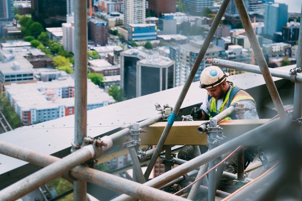 a worker positioned on scaffolding