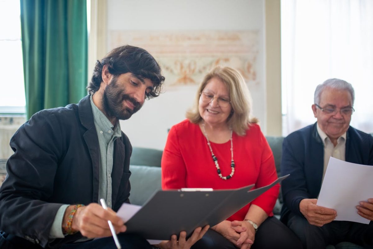 an insurance broker explaining policy details to an elderly couple